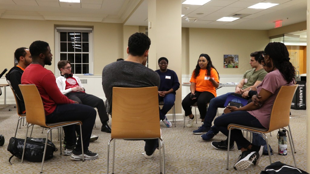 Moderator leads discussion among students